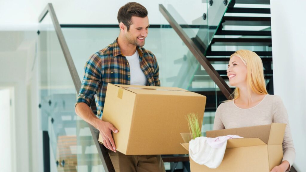 couple moving houses packing boxes new home