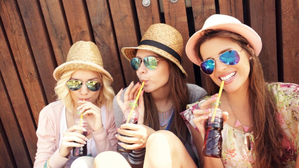 girl friends drinking soda pop happy