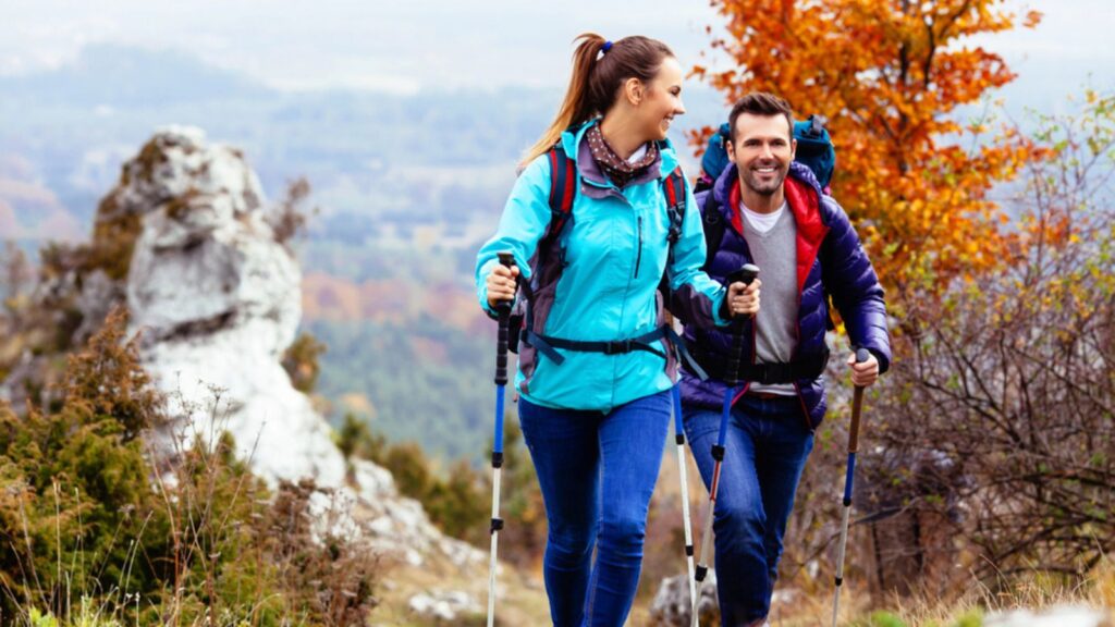 happy couple hiking mountain town outdoors fall autumn