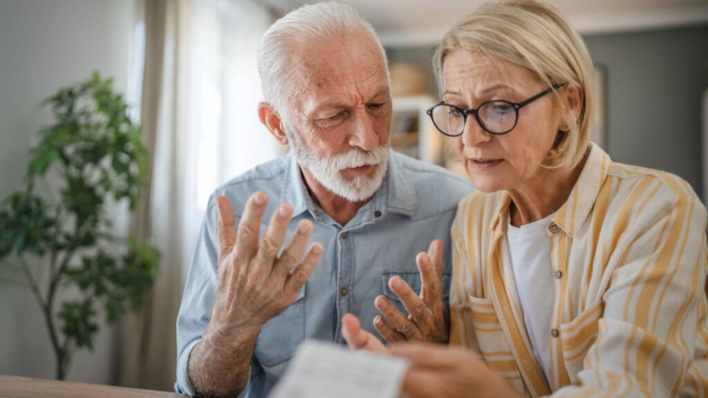 stressed old married retired couple finance budget money