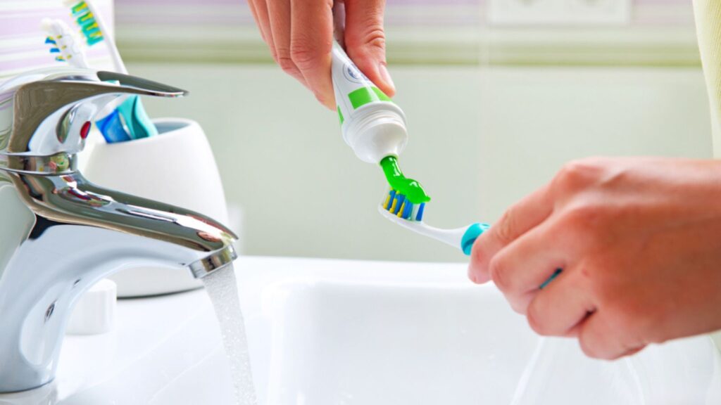 Brushing Teeth. Bathroom, putting toothpaste, oral hygiene