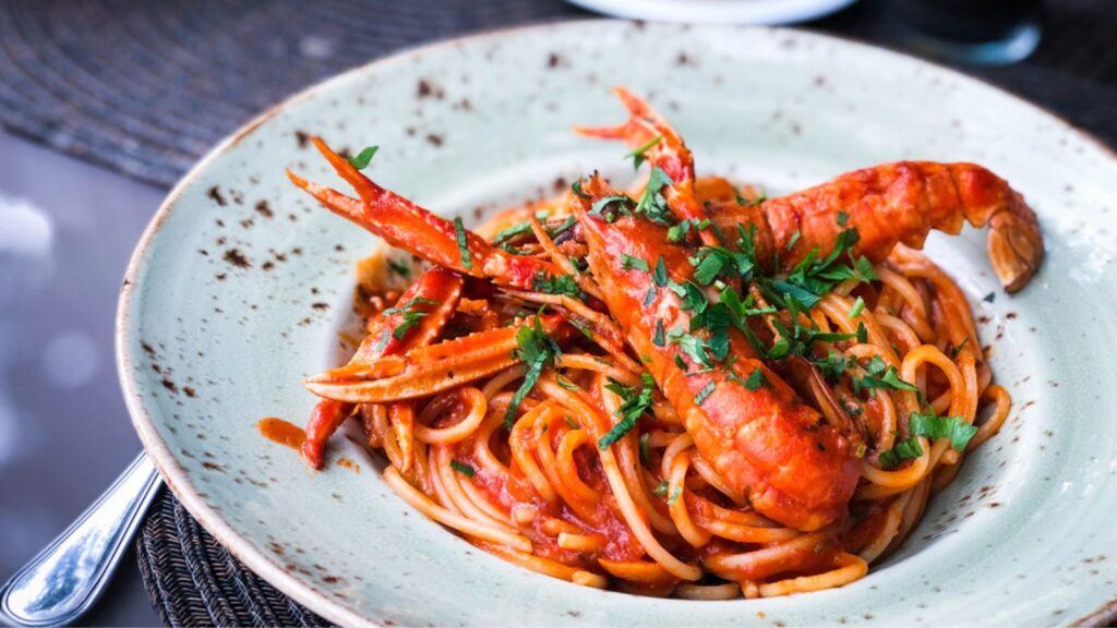 Delicious italian spaghetti with lobster, tomatoes sauce & fresh parsley, pasta