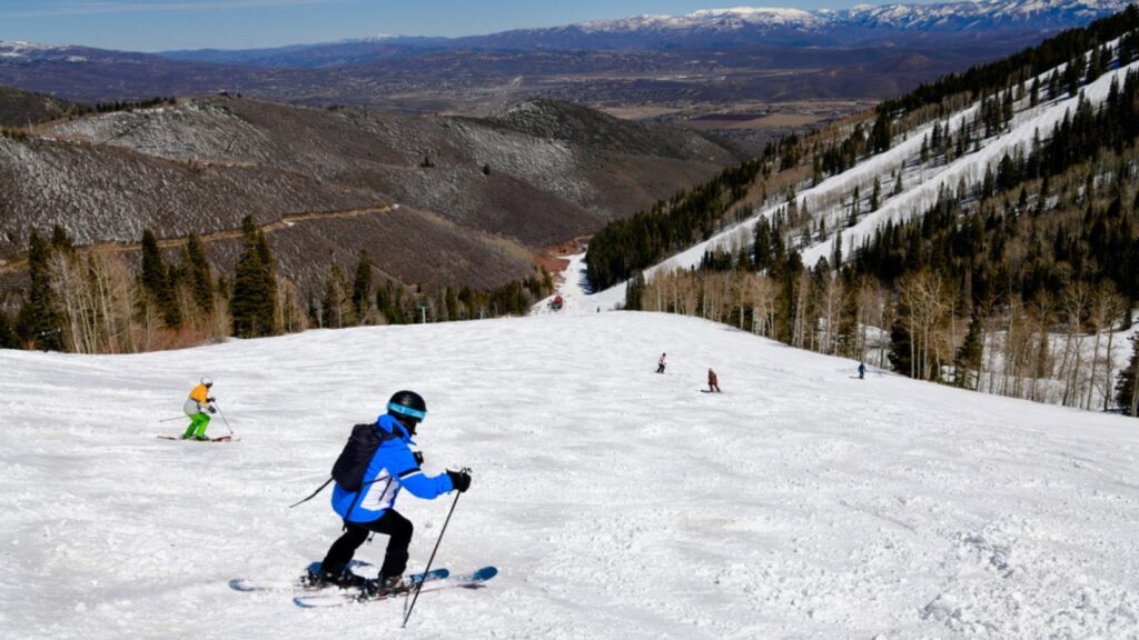 Enjoying skiing downhill at Park City Canyons Ski Area in Utah. Late spring weather conditions. Amazing sunny day and beautiful nature around