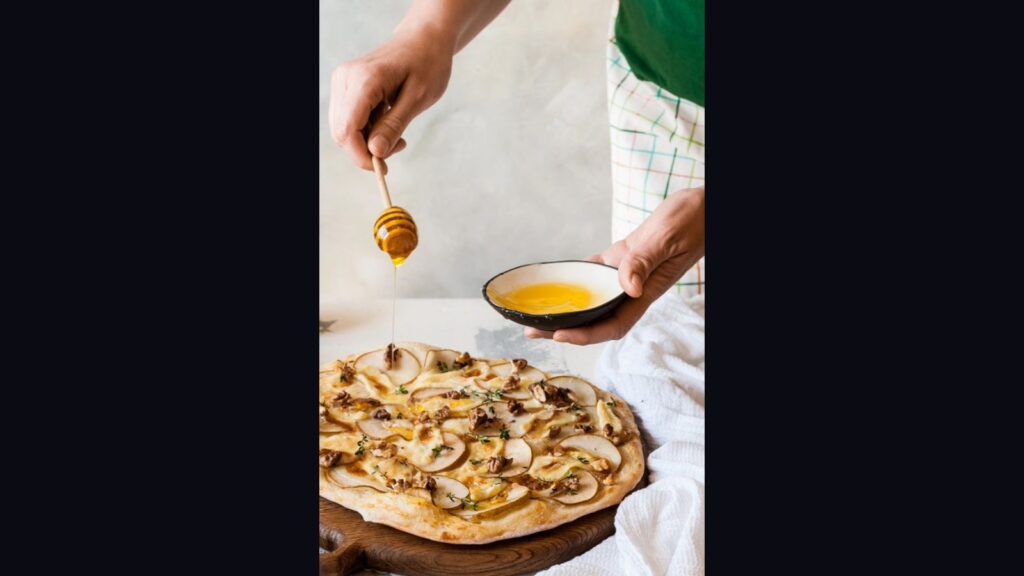 Female Drizzling Pear Pizza with Honey