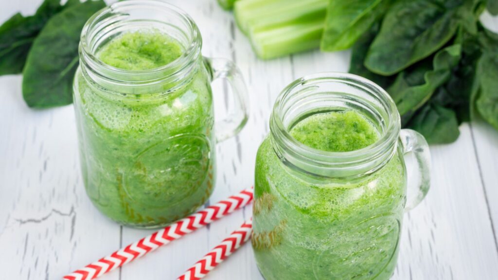 Green smoothie with celery, cucumber, spinach, apple and lemon