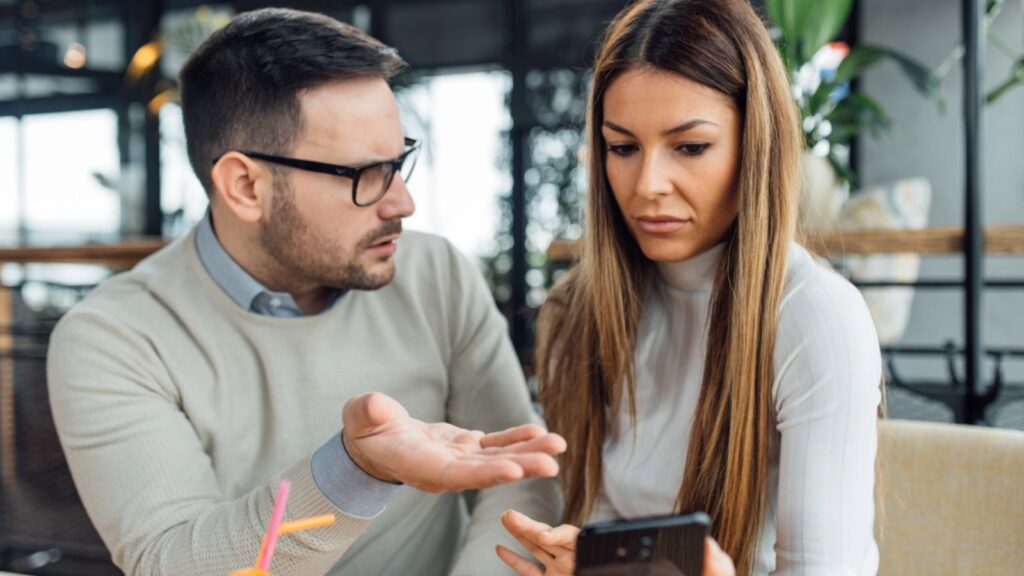 Man showing phone to his woman
