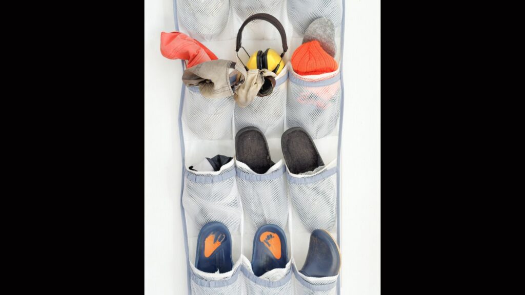 Messy over the door organizer with various clothing accessories