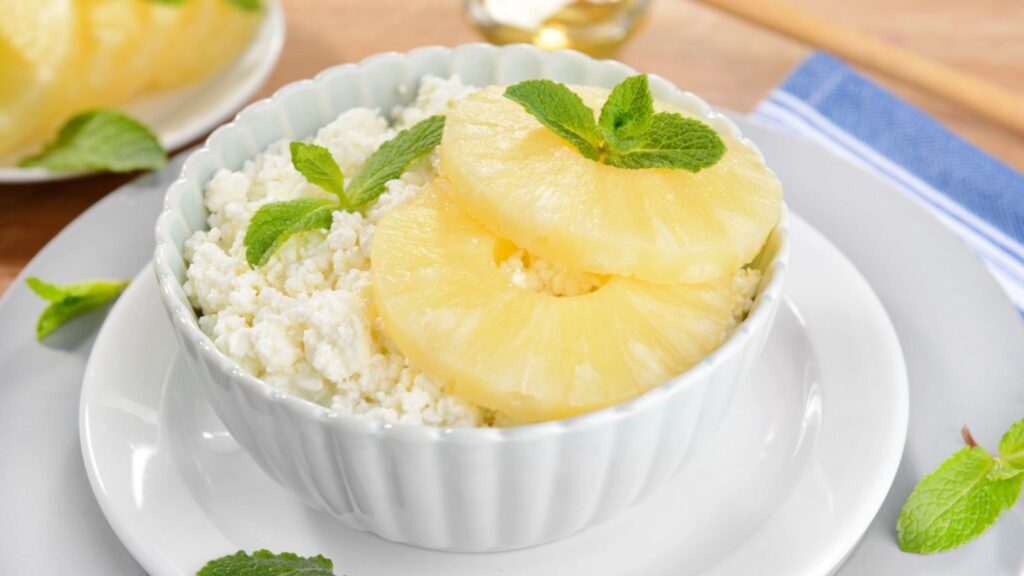 Bowl of tasty cottage cheese with pineapple
