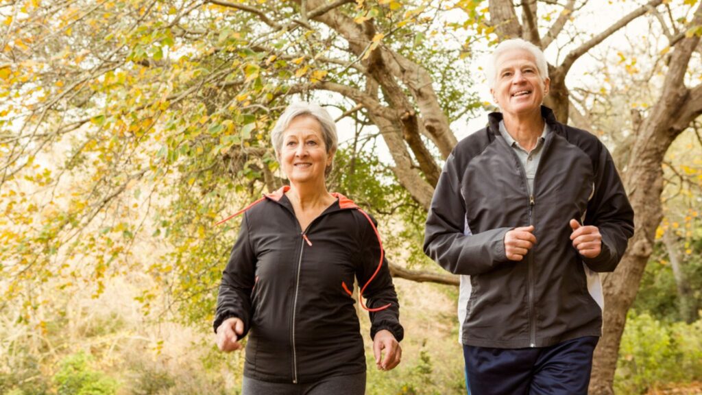 Senior couple running in the park