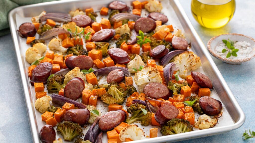Sheet pan dinner with sausage and vegetables roasted and ready to eat broccoli and cauliflower