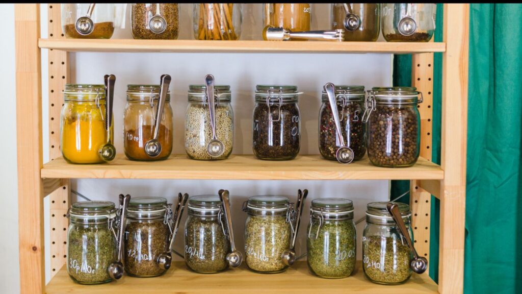 Shelves with a selection of spices and grains in glass jars