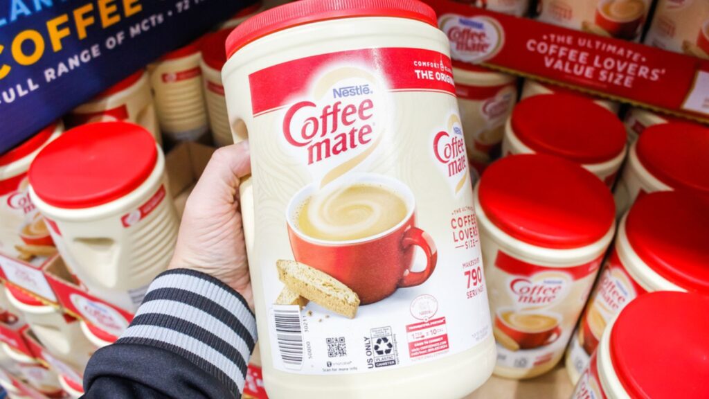 Tustin, California, United States A hand holds a container of Nestle Coffee Mate instant coffee on display at a local big box grocery store.