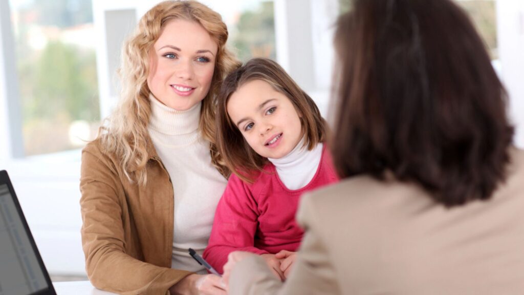 Woman in real-estate agency with kid