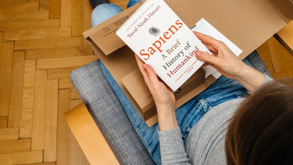 Woman unpacking unboxing Amazon Prime cardboard box