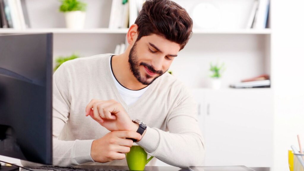 Young businessman looking at his watch