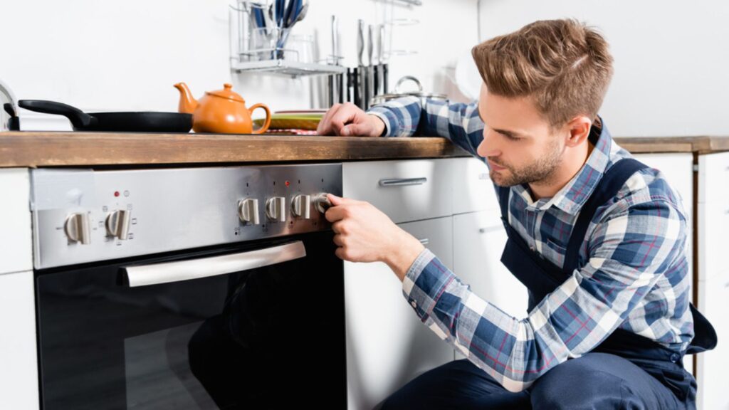 man preheat oven in kitchen baking