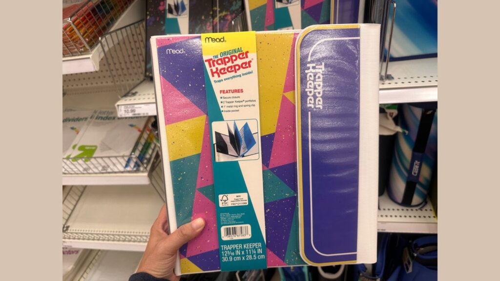 Plymouth, Minnesota - July 30, 2023: Hand holds up a throwback 1990s trapper keeper portfolio folder system on sale at a Target store