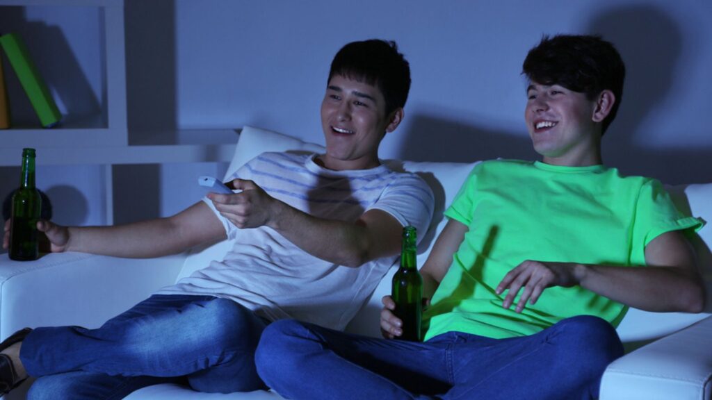 Two friends watching football at home of blacking-out