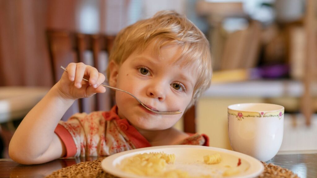 little boy eating mashed potatoes