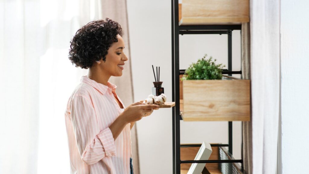 Woman with Aroma Reed Diffuser and Cotton at Home