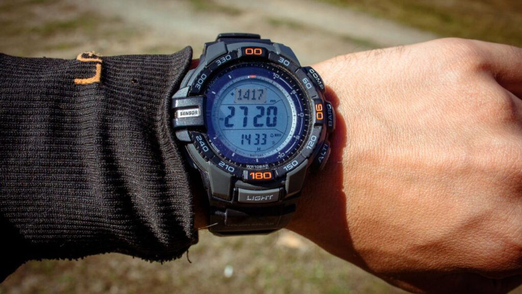 A clock with an altimeter on a sports watch on top of a mountain - digital watch