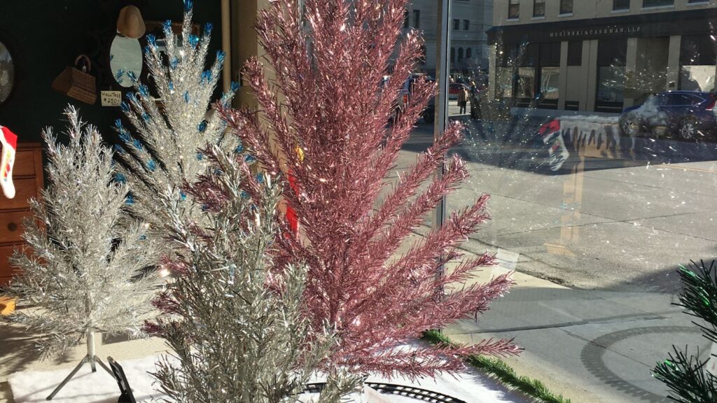 A rare pink Evergleam Aluminum Christmas tree graces the window of the Washington St. Antique Mall in downtown Manitowoc, WI.