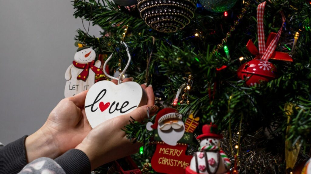 Hanging Christmas decorations and ornaments in the Christmas tree
