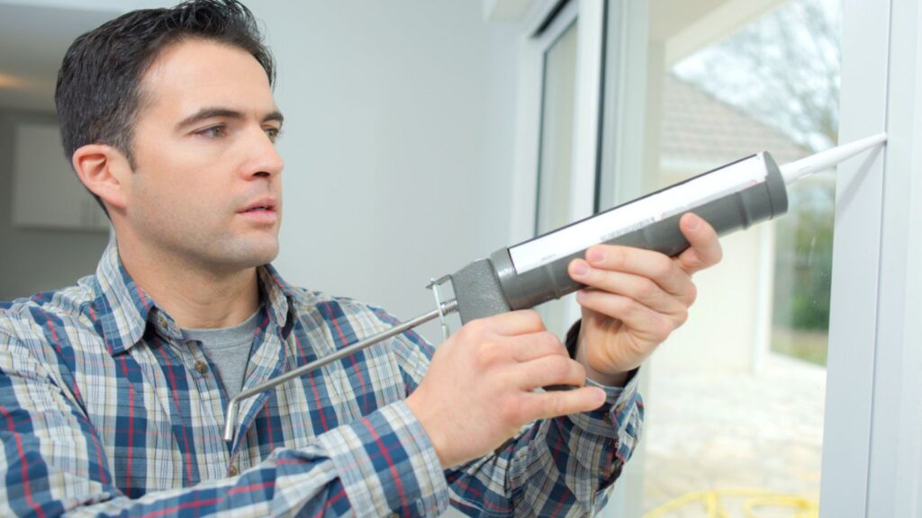 Man caulking a new window