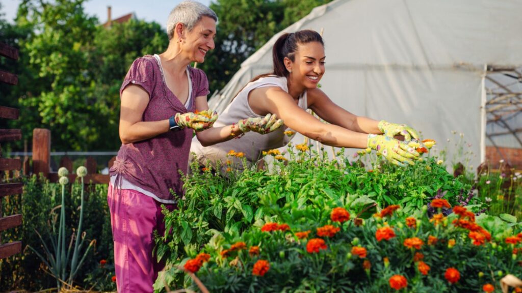Mother and daughter gardening together.Gardening discovering and teaching.