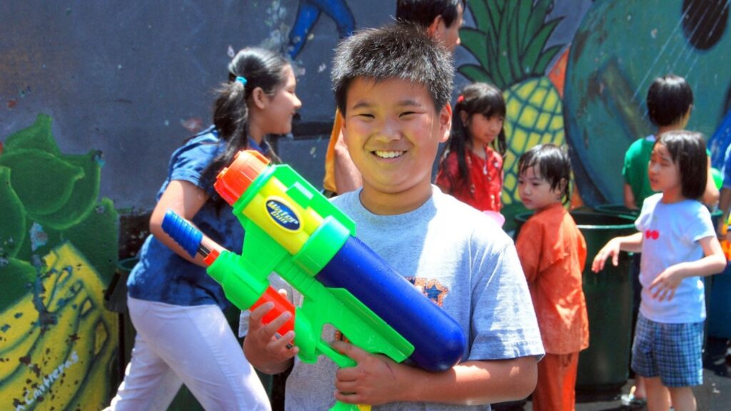 New York City - July 12, 2009 Asian boy with super soaker water gun at the annual Burmese Thingyan Water Festival in Chinatown