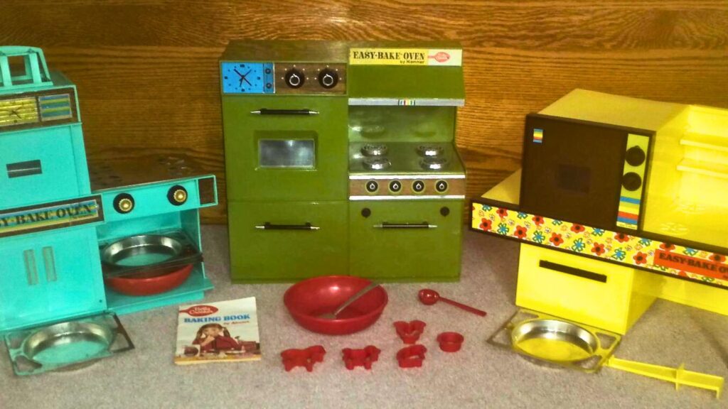 Photo showing the first three versions of Easy-Bake oven. From left Regular model # 1600 (1963), Premier model # 1500 (1969), and Mod model # 1360 (1971).