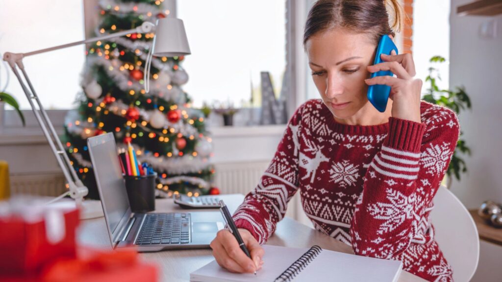 Women talking on smart phone and writing notes