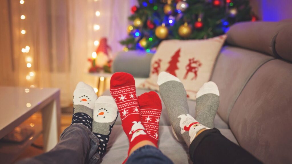 christmas cozy socks on couch tree lights