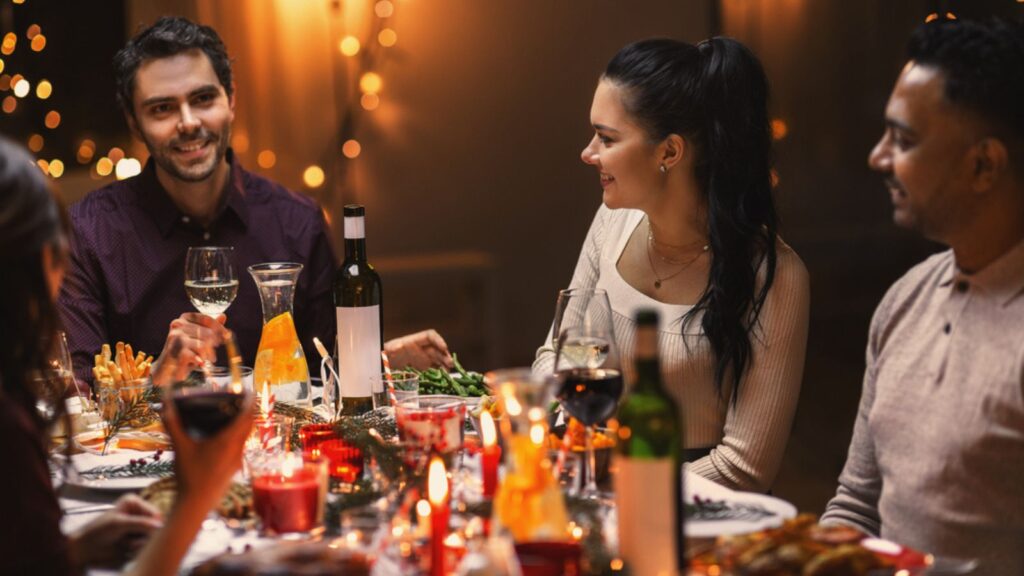 Happy friends drinking wine at christmas party