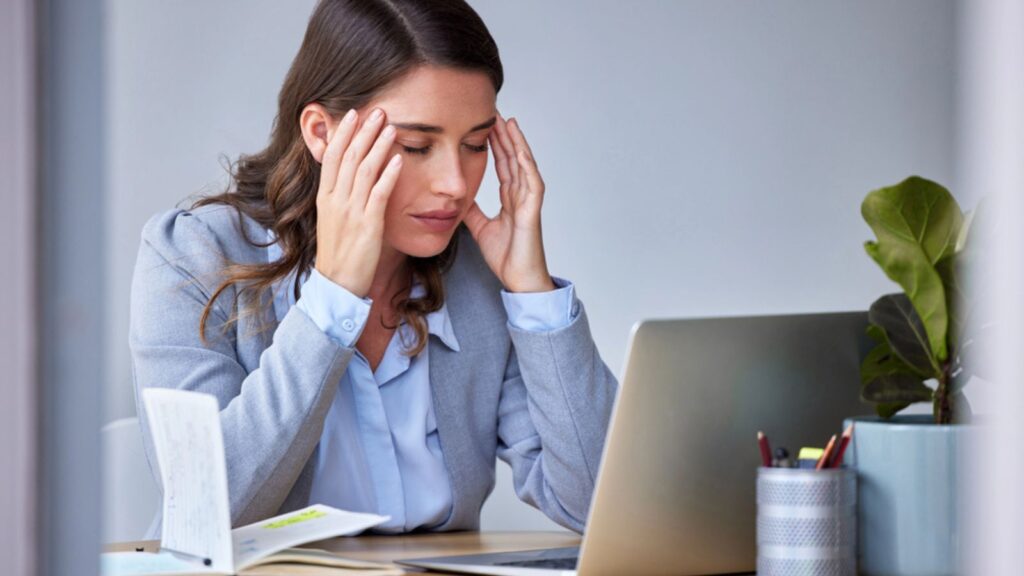 Shot of a businesswoman experiencing a headache, tired at work